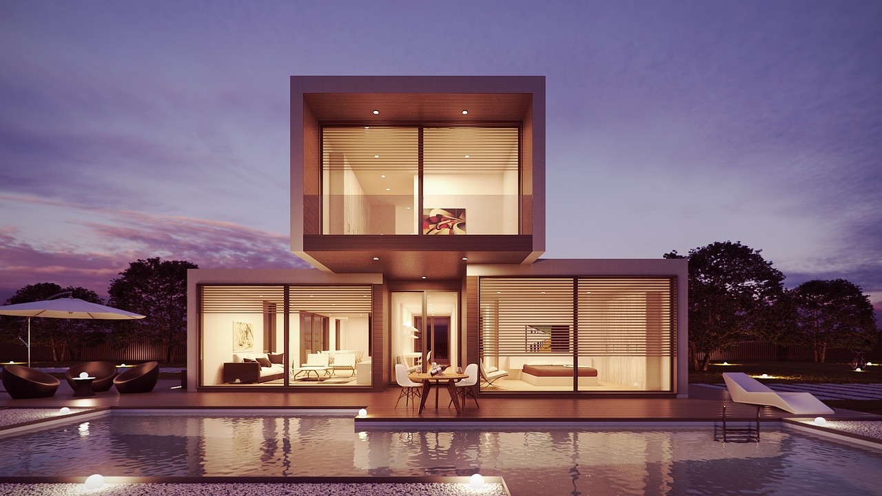 A modern house with a lit glass living area and a pool at dusk